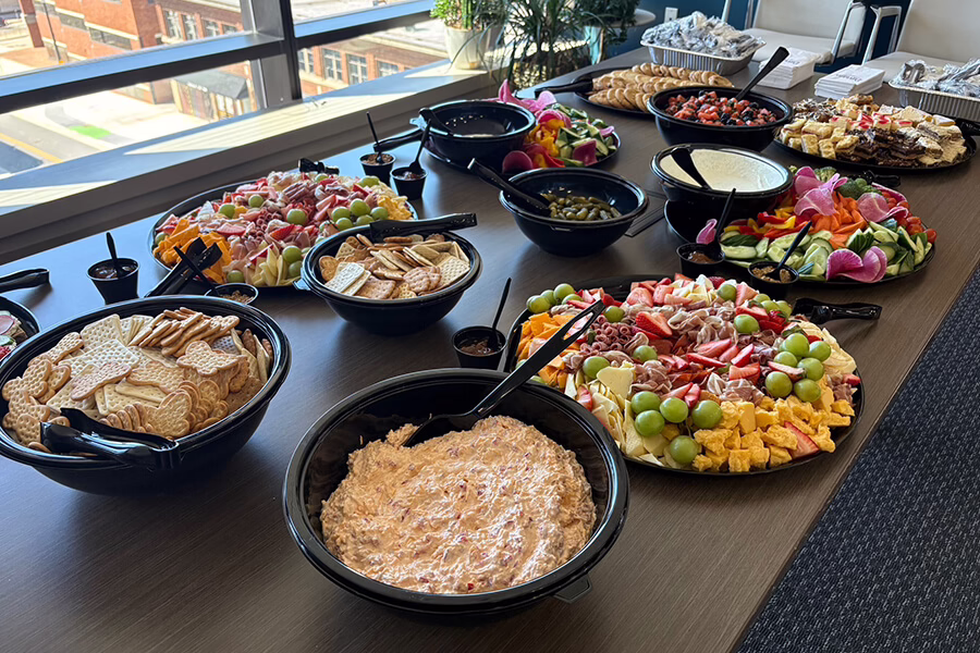 Table with food in disposable food trays on it