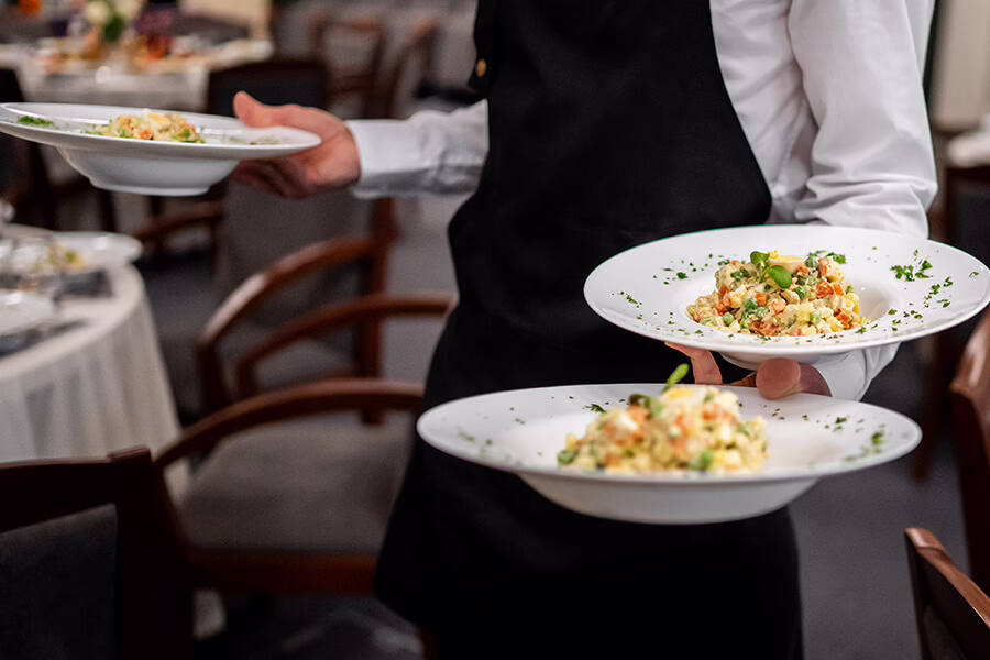 Full service catering, waiter with plates