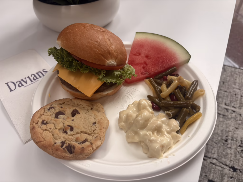 Davians plate of picnic food. Burger, watermelon, green beans, mac and cheese and cookie